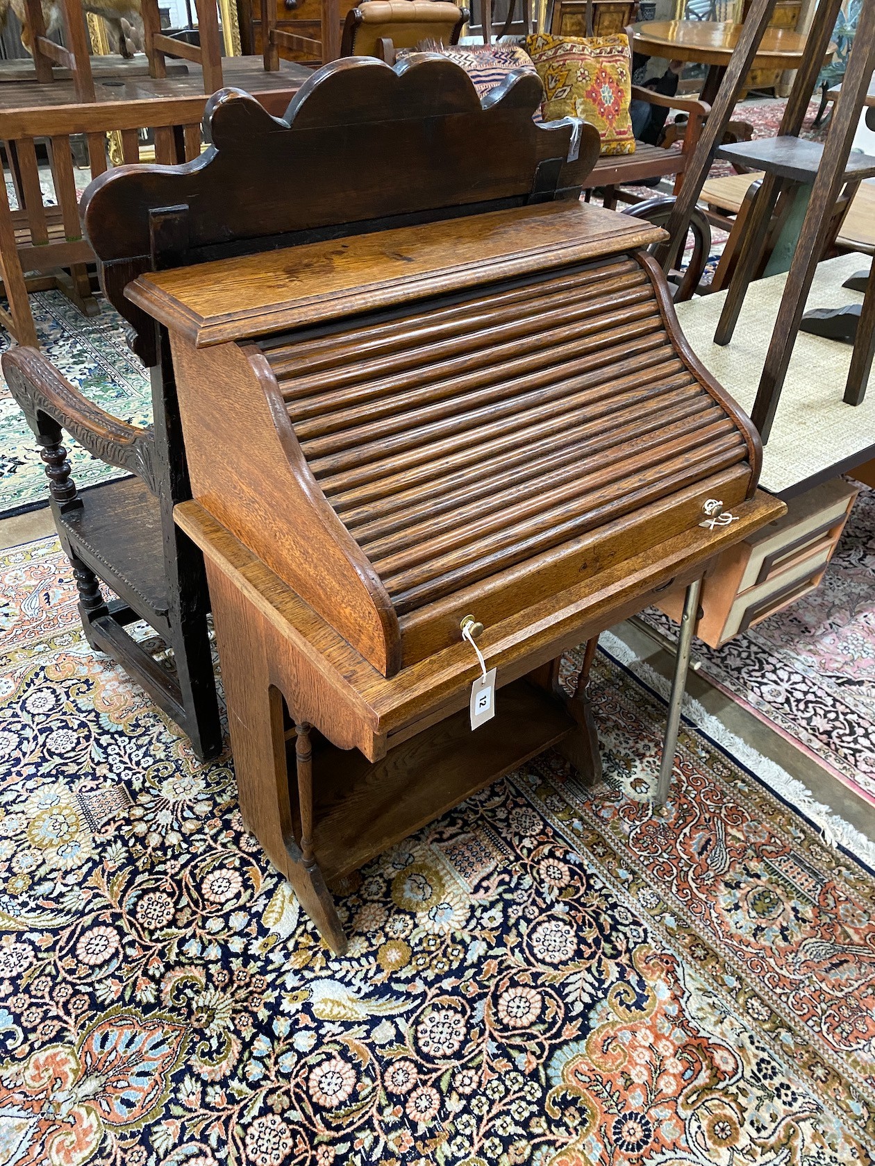 A 1920's oak roll top bureau with 'S' shaped tambour, width 69cm, depth 46cm, height 102cm